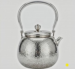 Hand-Hammered sterling silver teapot with arched handle £5000 order number 555. This Hand-Hammered sterling silver teapot features an attractive decorative knob